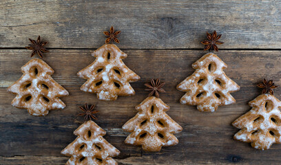 Christmas cookies in the shape of a Christmas tree. New Year's food. Anise star. Festive baked goods. Gingerbread on the table. Pattern