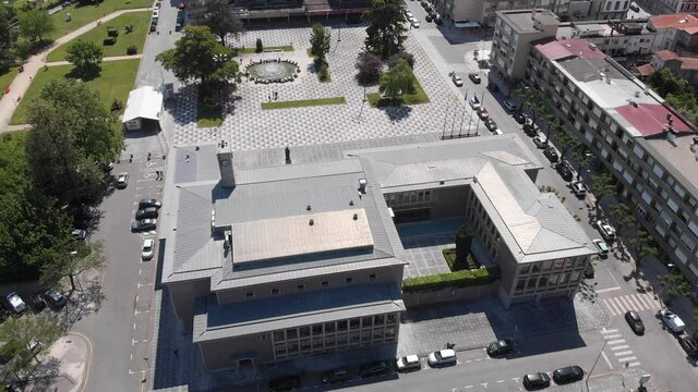 DRONE AERIAL FOOTAGE: Santo Tirso, Portugal - May 1, 2021: Santo Tirso City Hall with the statue of Saint Rudesind (Sao Rosendo) in front, the 25th of April Square (Portuguese: Praca 25 de Abril).