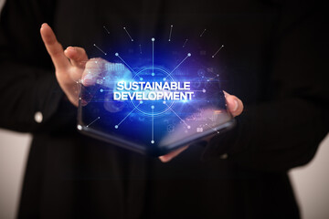 Fototapeta premium Businessman holding a foldable smartphone, new business concept