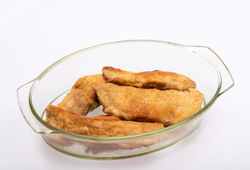 Breaded fish fillets in a glass, heat-resistant dish