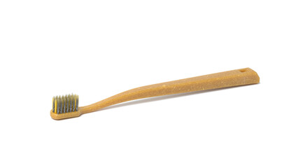 brown plastic toothbrush on white background