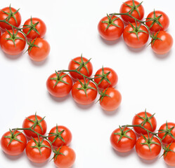 red ripe tomatoes on a green branch on white background, healthy vegetable