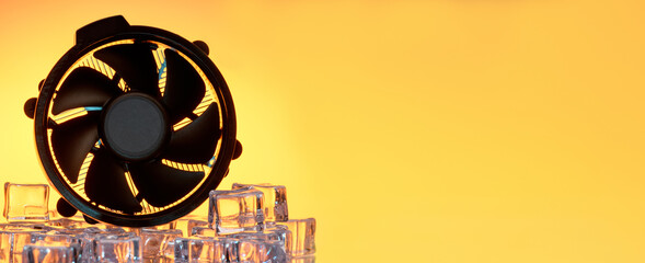 Computer cooling fan in ice with orange backlight. Cooler overheat concept. Banner