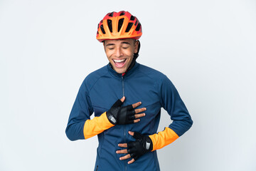 Young cyclist Brazilian man isolated on white background smiling a lot - obrazy, fototapety, plakaty