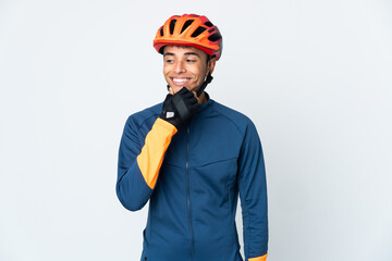 Young cyclist Brazilian man isolated on white background looking to the side and smiling - obrazy, fototapety, plakaty