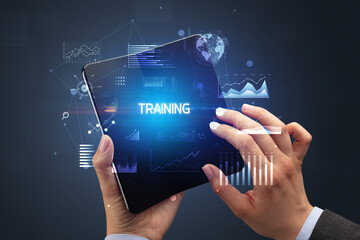 Businessman holding a foldable smartphone, business concept