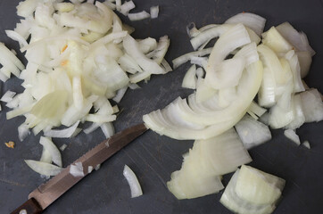 cutting onion on plastic board
