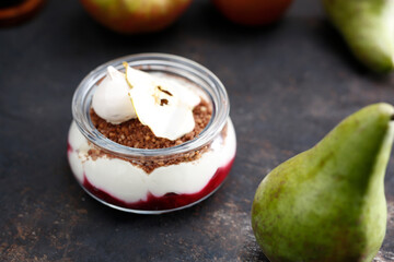 Dessert in a jar. Raspberry mousse with yoghurt cheesecake and chocolate crumble. Culinary photography.