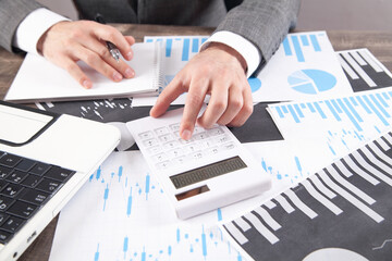Fototapeta na wymiar Businessman using calculator for analysis marketing plan. Business, Accounting