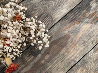 Beautiful dry flowers on a wooden background in a diagonal orientation. Copy space.