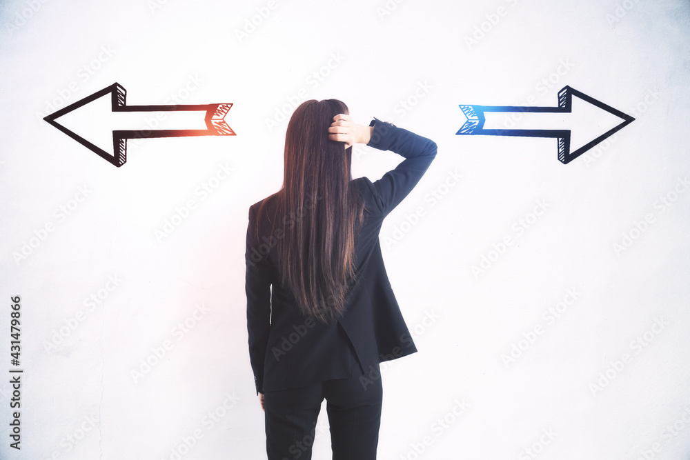 Poster businesswoman standing puzzled in front of a wall with two black silhouette arrows pointed in opposi