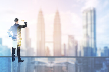 Businessman standing and watching far away with a cityscape in the background, future success and promotion concept. Double exposure