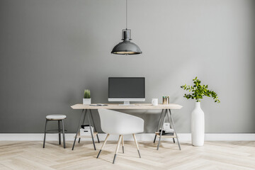 Stylish classic work place at home with modern computer monitor, white chair and vase on wooden...