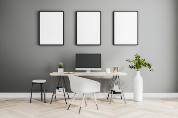 Three white blank posters on black frame on grey wall in stylish home room with classic style...