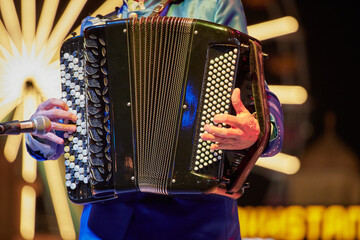 A musician performing on an accordeon, close-up, Sheikh Zayed Festival - obrazy, fototapety, plakaty
