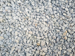 Gravel stones flooring pattern surface texture. Close-up of exterior material. Small road stone background, dark gravel pebbles stone