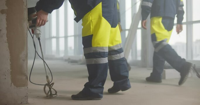 Cropped short of builder putting down tools and going home in evening