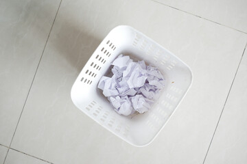 crumpled paper ball in a bin top view 