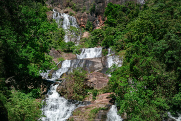 Fototapeta na wymiar Beautiful Rawana Ella waterfall, surrounded by green tropical forest.