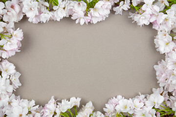 Fototapeta na wymiar Cherry spring flowers branches background. Valentines, womens, mothers day, easter, birthday, wedding or spring holiday flat lay. Top view. Copy space.