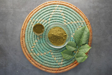 The wooden bowl with rehydrated henna on table 