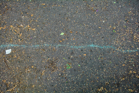 Bumpy road with chalk blue line marking of gray cracked asphalt. Travel concept