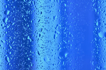 Neon lights behind water drops close up