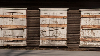 Facade boarded up with wooden planks. Boarded up wooden shutter in an old abandoned house.