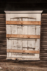 Facade boarded up with wooden planks. Boarded up wooden shutter in an old abandoned house.