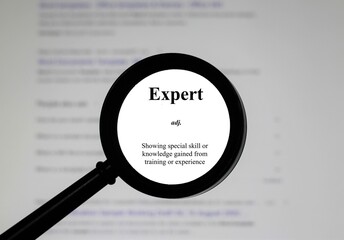 Selective focus on word expert, word in a dictionary. Close up of an English dictionary page with...