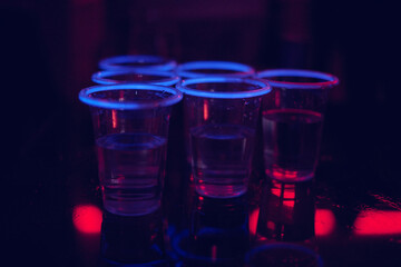 neon glowing cups at a party 