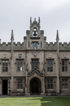 Gothic architecture facade with tower clock and bell 
