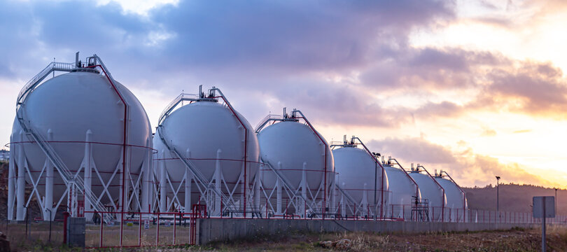 Gas storage tanks at sunset.