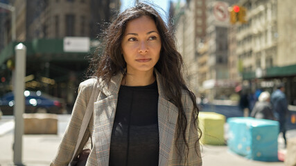Woman in city walking street serious face