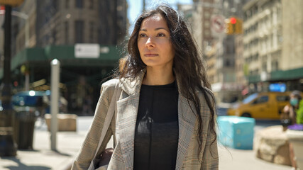 Fototapeta premium Woman in city walking street serious face