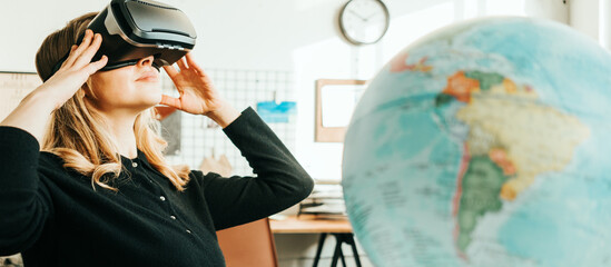 Smiling pretty woman with vr headset and world globe