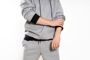 man in a gray tracksuit on a white background
