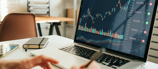 Woman working with investment stock market using laptop, analyzing trading data