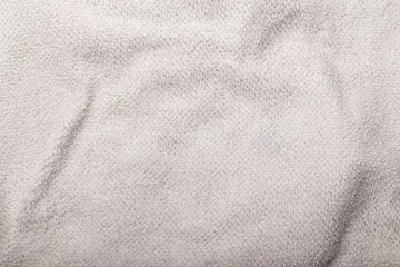 Fototapeta na wymiar Texture of white fleece fabric, background or backdrop. Clothing, inside or back side, sewing, gressmaking, haberdashery. Copy space.