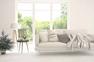 Fototapeta premium White living room with sofa and summer landscape in window. Scandinavian interior design. 3D illustration