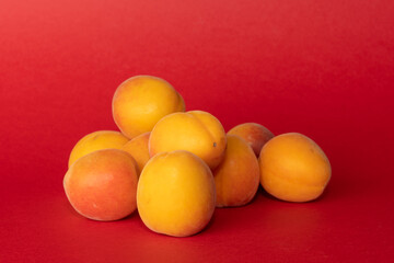 Pile of small, fresh, ripe, juicy, peaches on a colourful background, stock picture.
