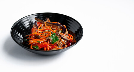 Vegetable salad with fried eggplant on a light background. Vegetarian food. Isolated lettuce in a...