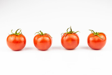 Four tomatoes isolated on a white background.