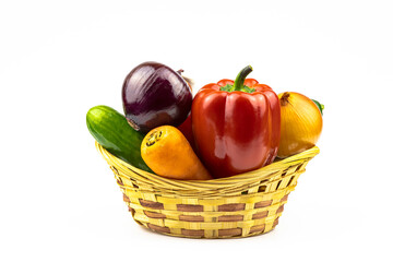 Fresh vegetables in a wicker basket isolated on a white background