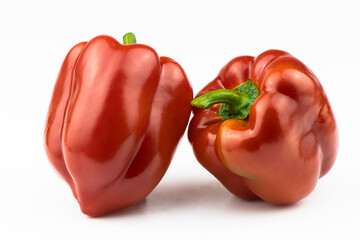 A red, fresh sweet pepper is isolated on a white background.