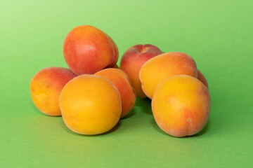 Pile of small, fresh, ripe, juicy, peaches on a colourful background, stock picture.