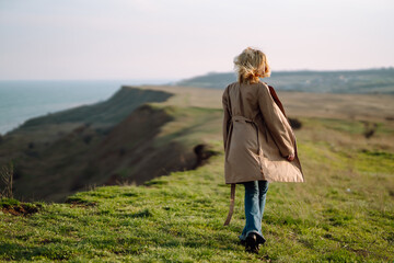 Portrait of beautiful young woman enjoys a spring sunny day. People, lifestyle, travel, nature and vacations concept.