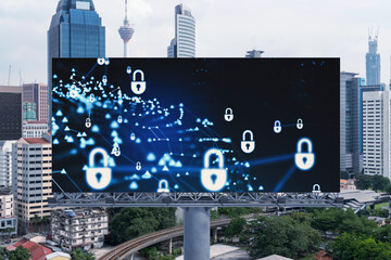 Padlock icon hologram on road billboard over panorama city view of Kuala Lumpur at day time to protect business, Malaysia, Asia. The concept of information security shields.