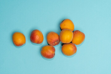 Pile of small, fresh, ripe, juicy, peaches on a colourful background, stock picture.