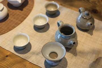 Asian food background with a tea set, cups, and teapot.